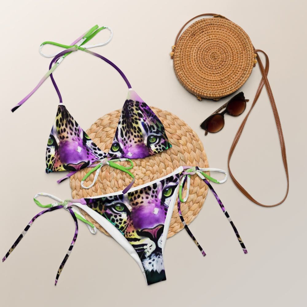 A pair of purple bikini top laying on the ground.