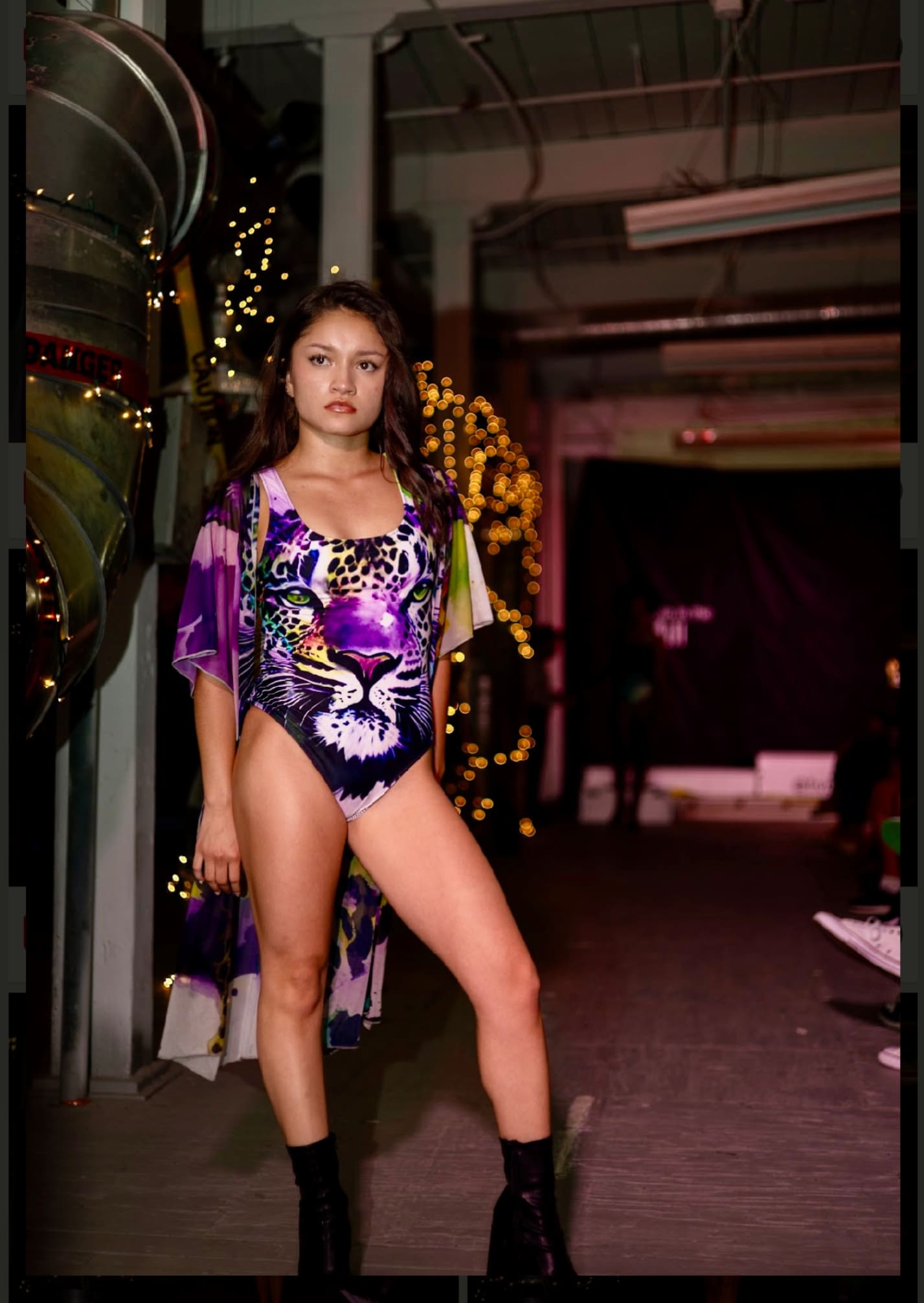 A woman in a bathing suit and purple tiger print swimsuit.