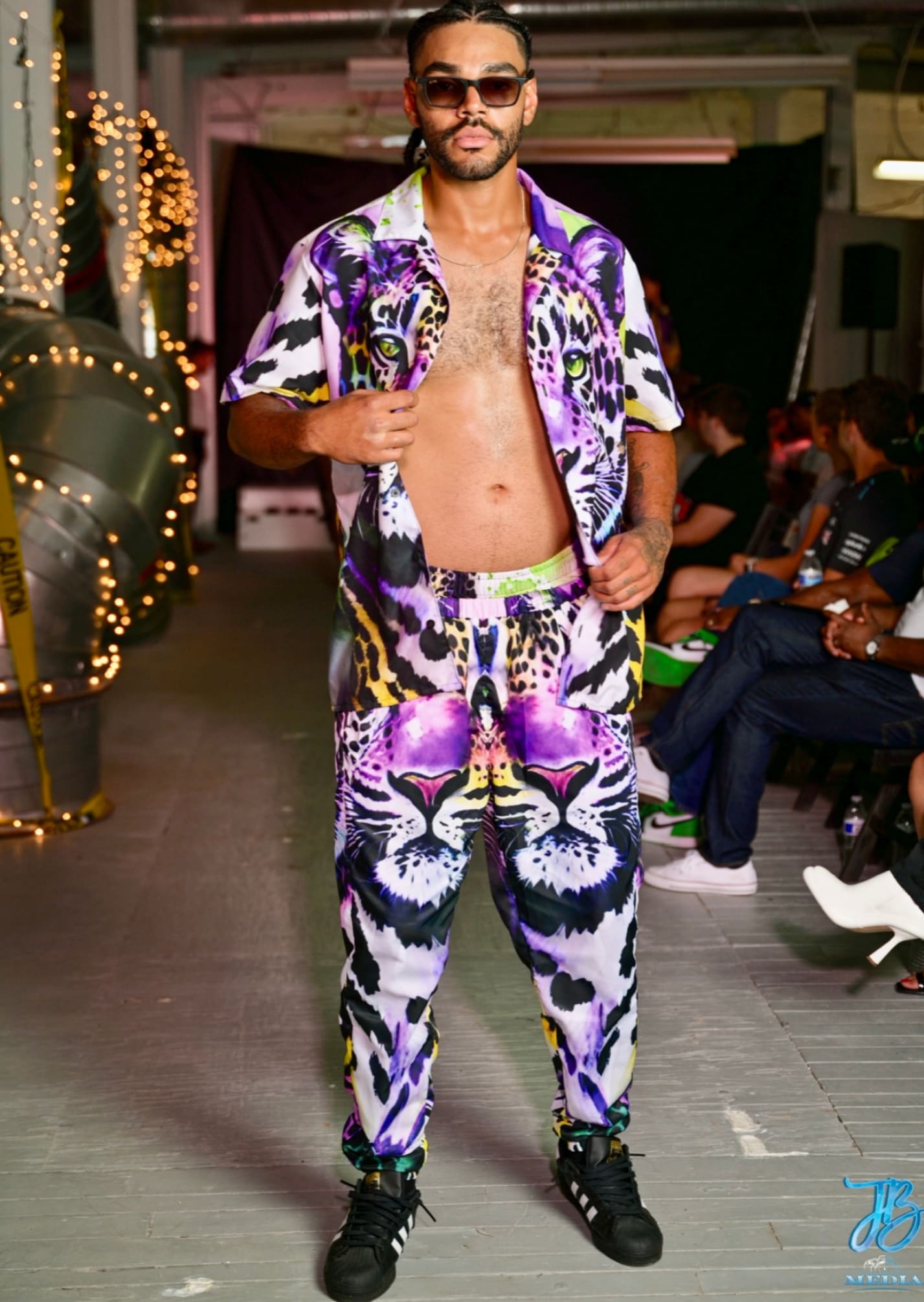 A man in purple and white tiger print outfit.