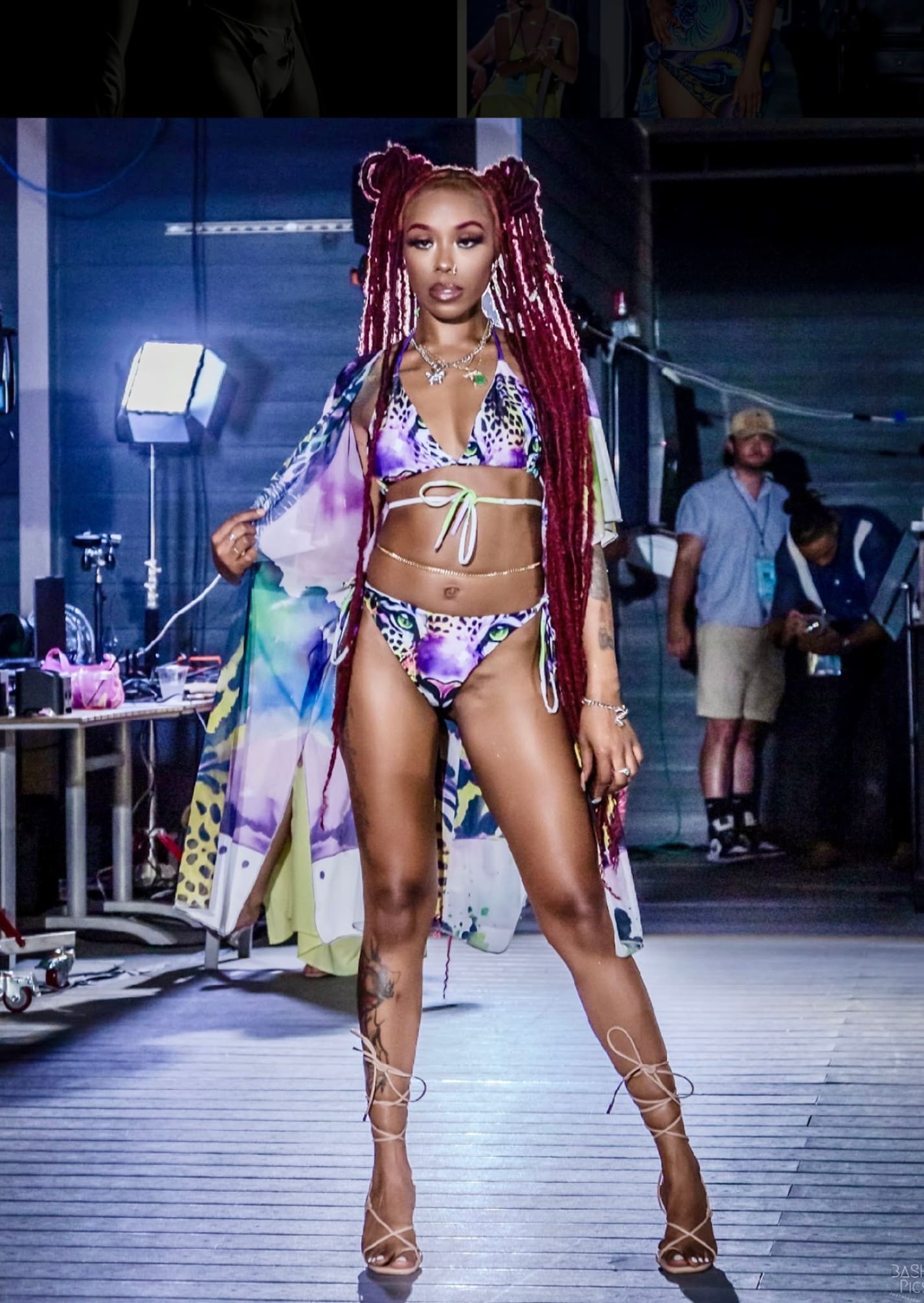 A woman in a bikini and dreadlocks on the runway.