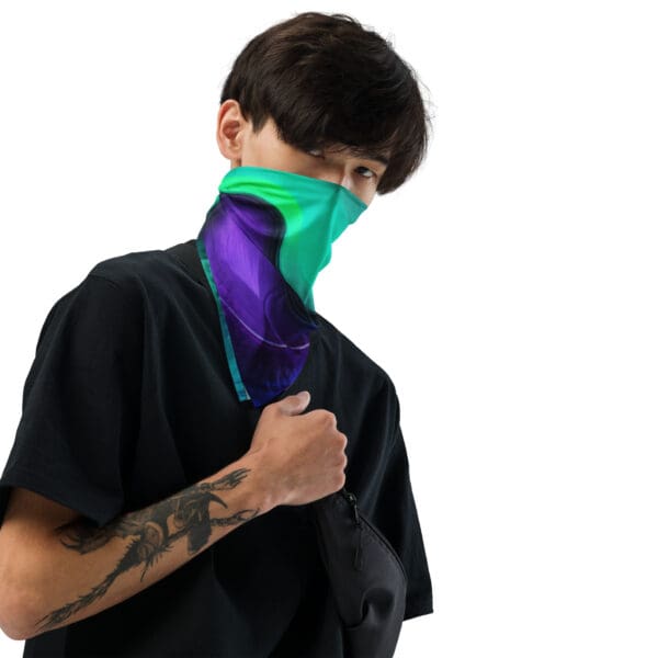 A man with tattoos and a green neck gaiter.