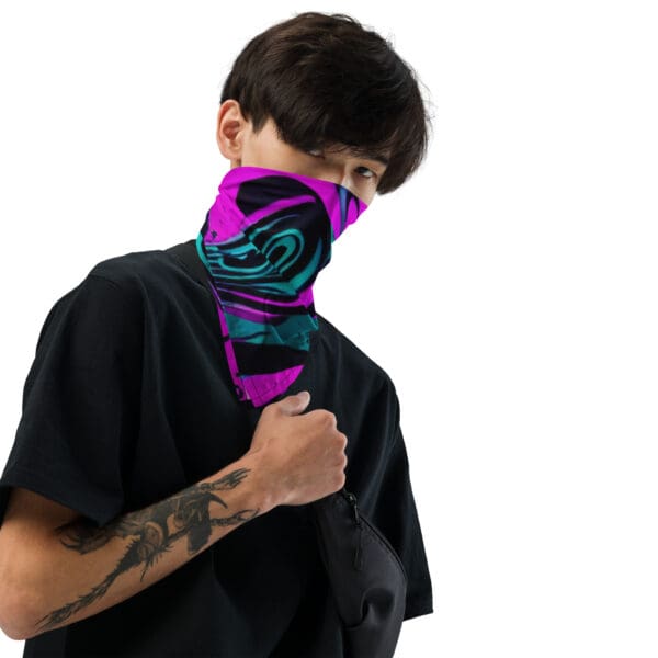 A man with tattoos wearing a purple and blue neck gaiter.