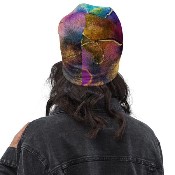 A person wearing a hat with a colorful design on it.