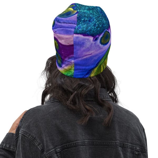 A person wearing a hat with an image of a fish on it.