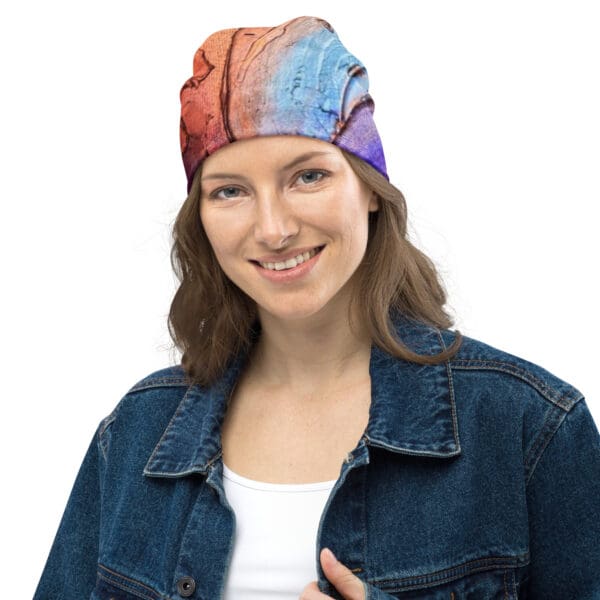 A woman wearing a denim jacket and a colorful hat.