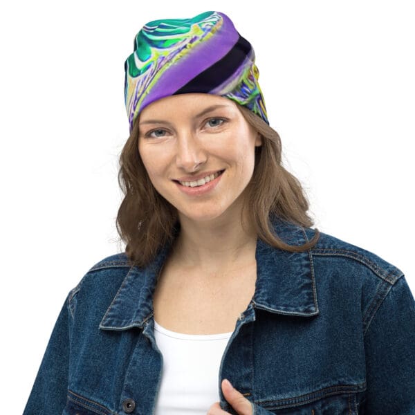 A woman wearing a blue jean jacket and purple hat.