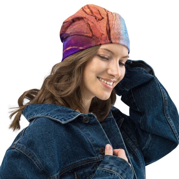 A woman wearing a denim jacket and a colorful hat.