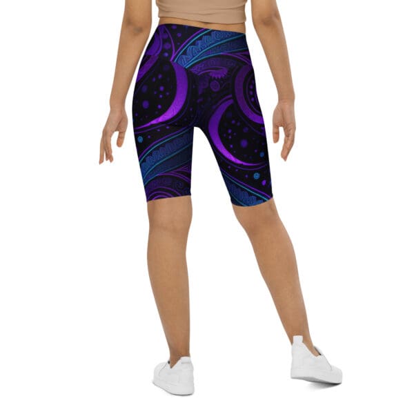 A woman wearing purple and blue shorts with an abstract design.