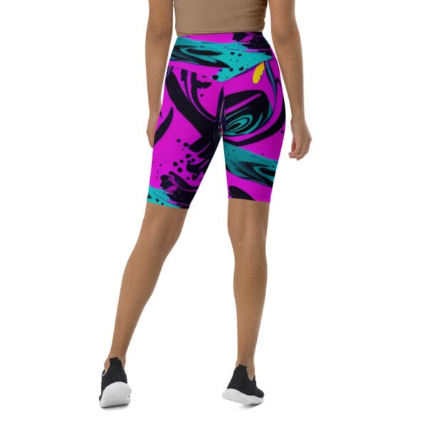 A woman wearing purple and black shorts with an abstract design.