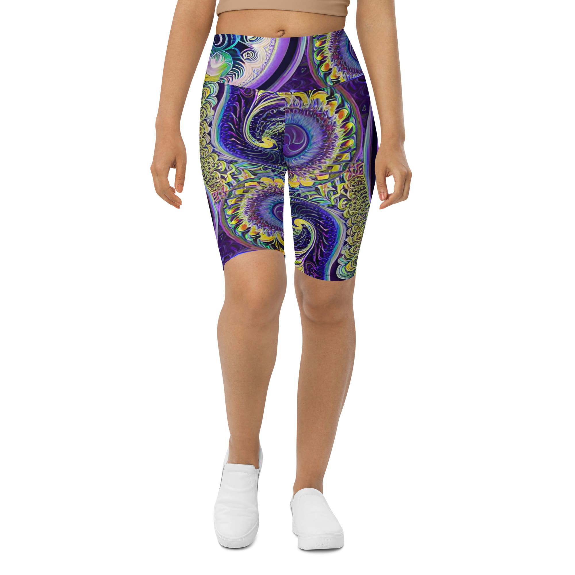 A woman wearing purple and blue shorts with an artistic design.