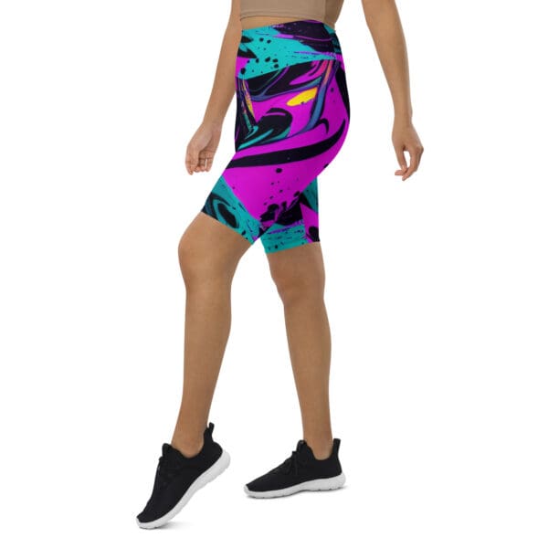 A woman wearing black and purple shorts with an abstract design.