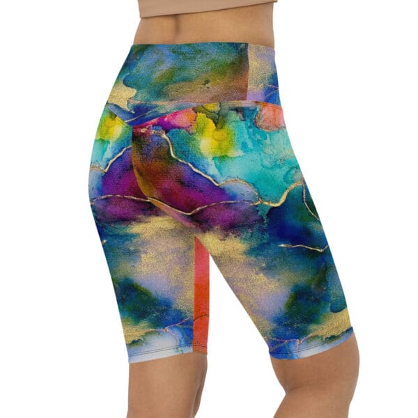 A woman wearing colorful shorts with abstract art.