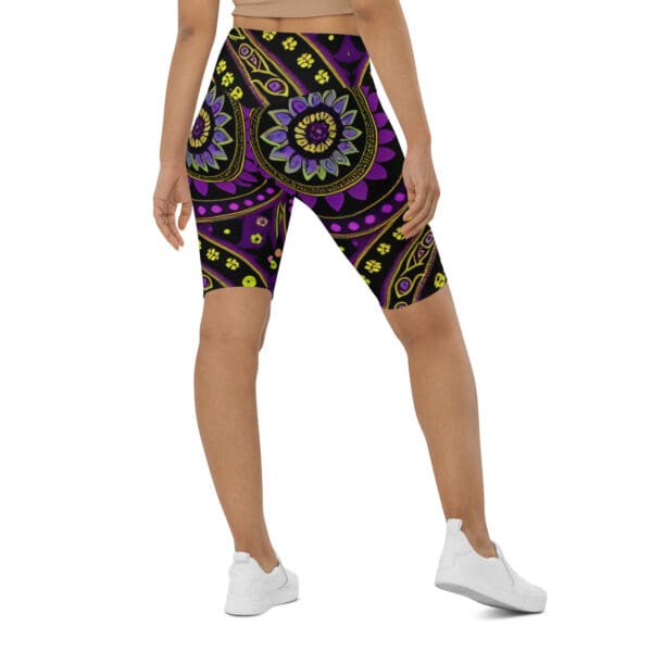 A woman wearing purple and yellow floral print bike shorts.