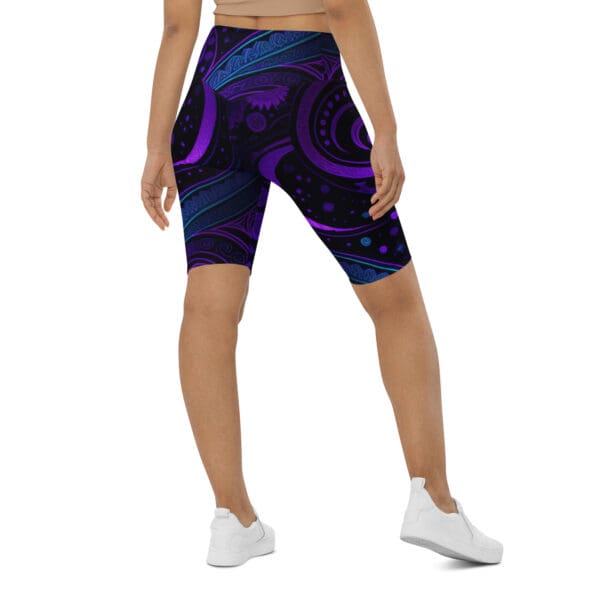 A woman wearing purple and blue shorts