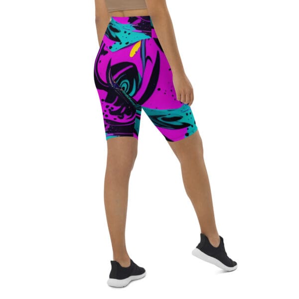 A woman wearing purple and blue shorts with an abstract design.