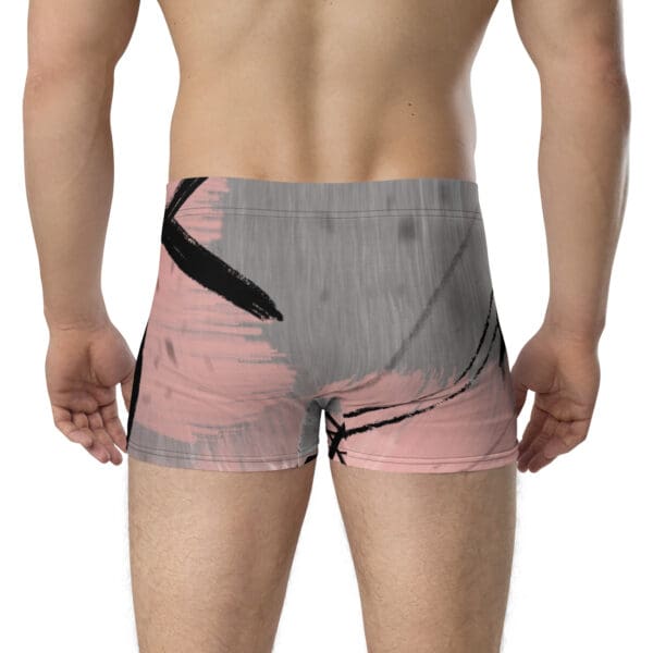 A man wearing grey and pink underwear with black lines.