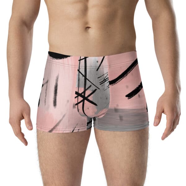 A man wearing a pair of pink and black boxers.