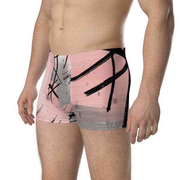 A man wearing pink and black underwear with an abstract design.