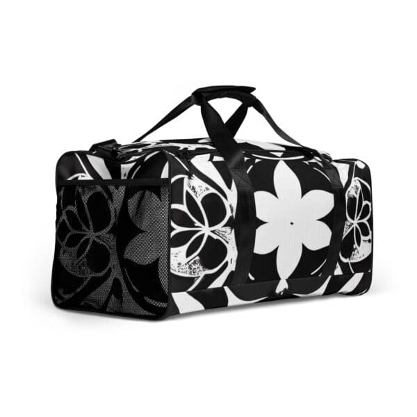 A black and white floral duffel bag with handles.