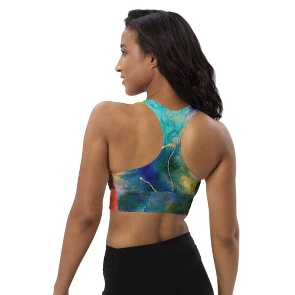 A woman wearing a sports bra with a painting of birds.