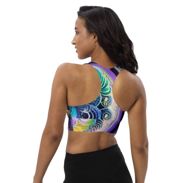 A woman wearing a sports bra with an artistic design.