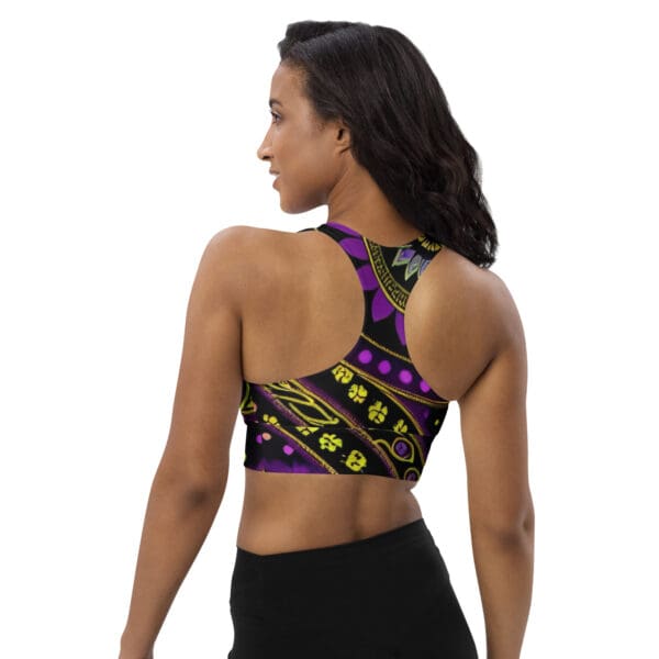 A woman wearing a purple and yellow sports bra.