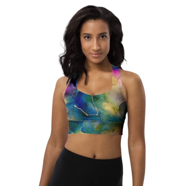 A woman wearing a sports bra with colorful painting on it.