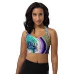 A woman wearing a sports bra with an artistic design.
