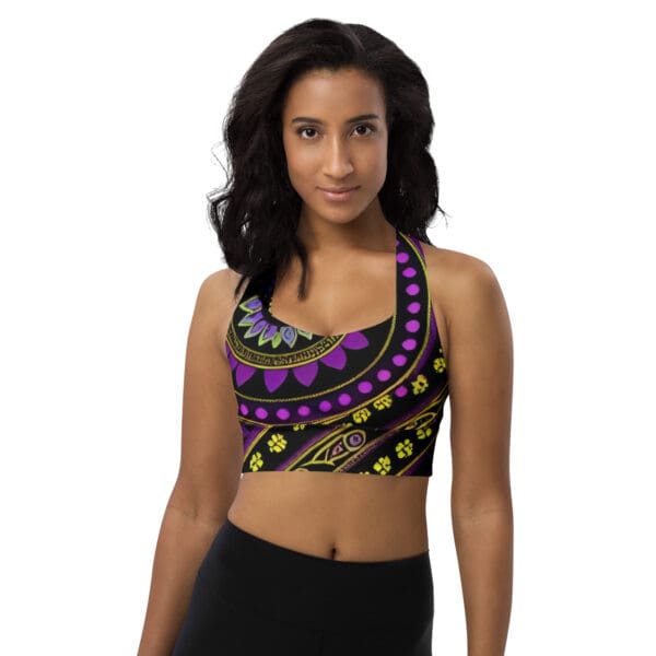 A woman wearing a purple and yellow patterned sports bra.