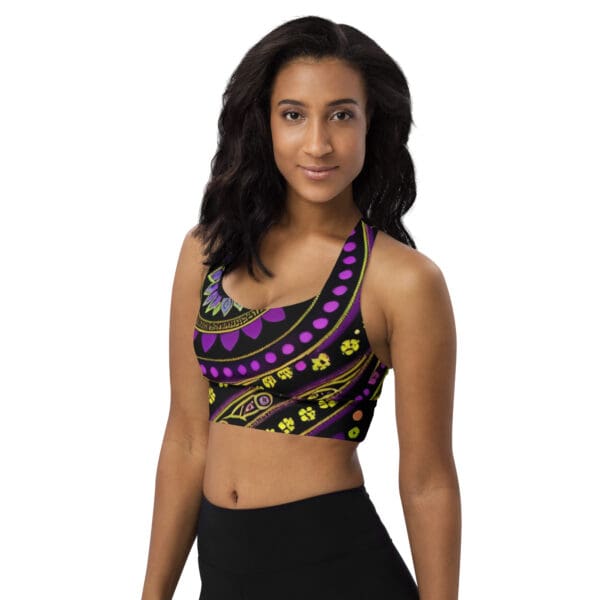 A woman wearing a purple and yellow patterned top.