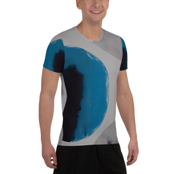 A man wearing a t-shirt with blue and black abstract design.