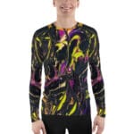 Smiling man wearing colorful abstract long-sleeve shirt.