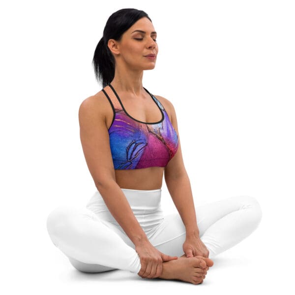 A woman sitting in the middle of her yoga pose.