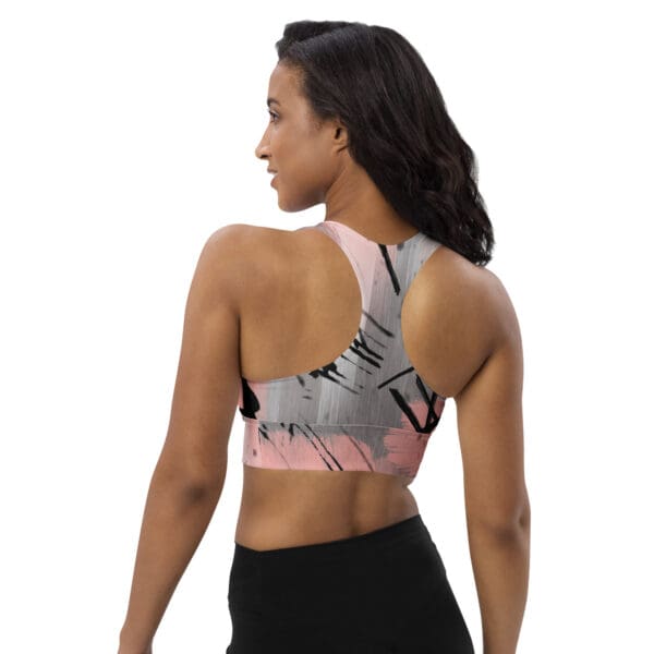 A woman wearing a sports bra with a picture of a person in the back.