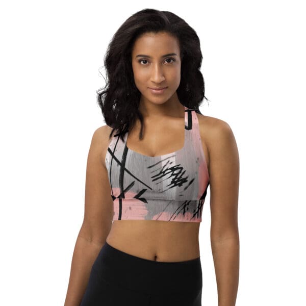 A woman wearing a sports bra with a black and white design.