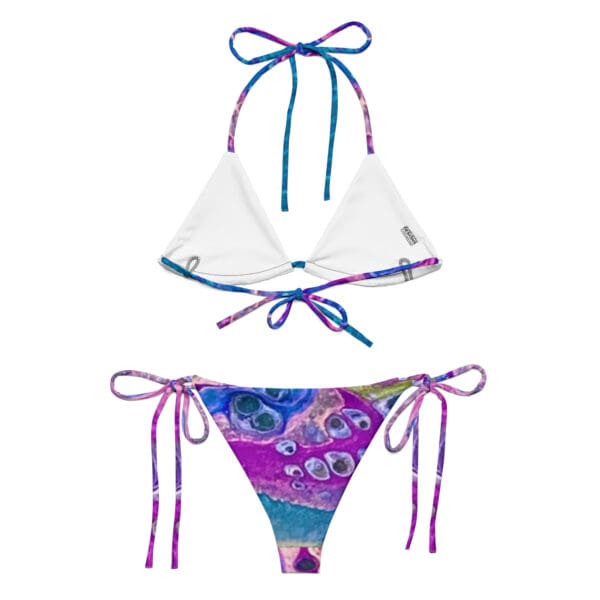 A bikini with two different colored ties on it