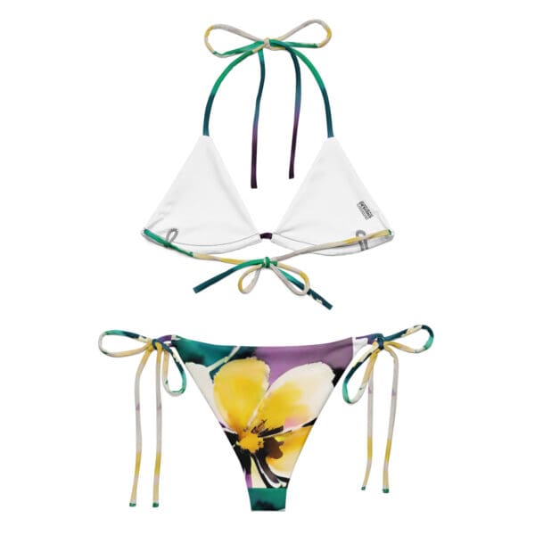 A bikini with a flower print and a green string.