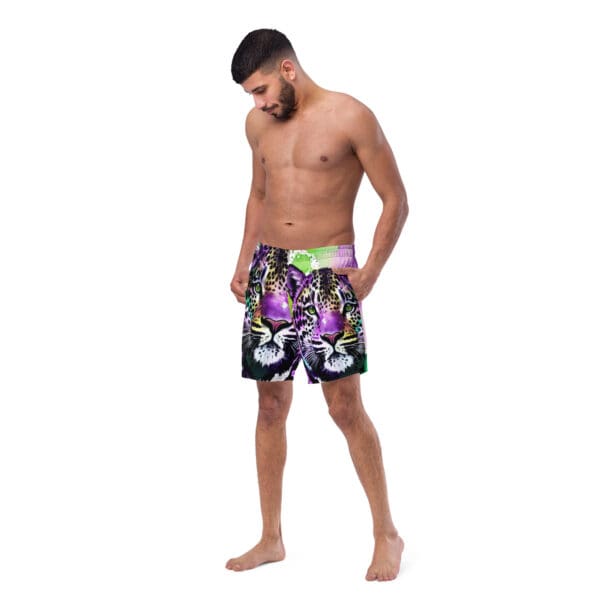 A man wearing black and purple swim trunks.