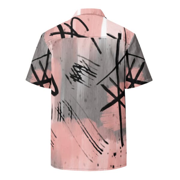 A pink and black shirt with graffiti on it