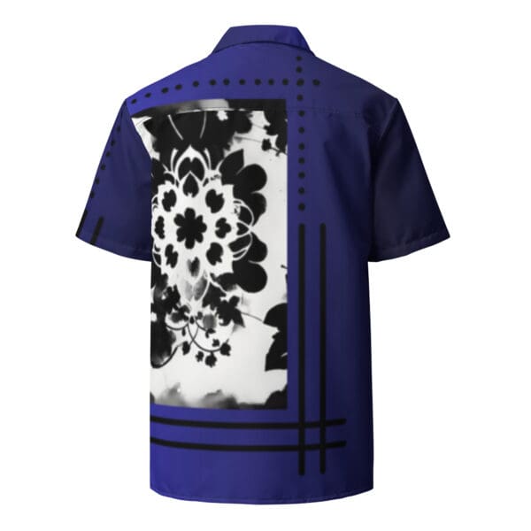 A blue shirt with black and white flowers on it.