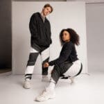 Two models in stylish black and white outfits.