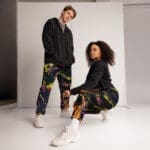 Couple posing in colorful streetwear outfits.