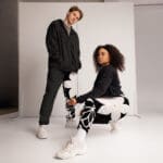 Two stylish models posing in urban attire.