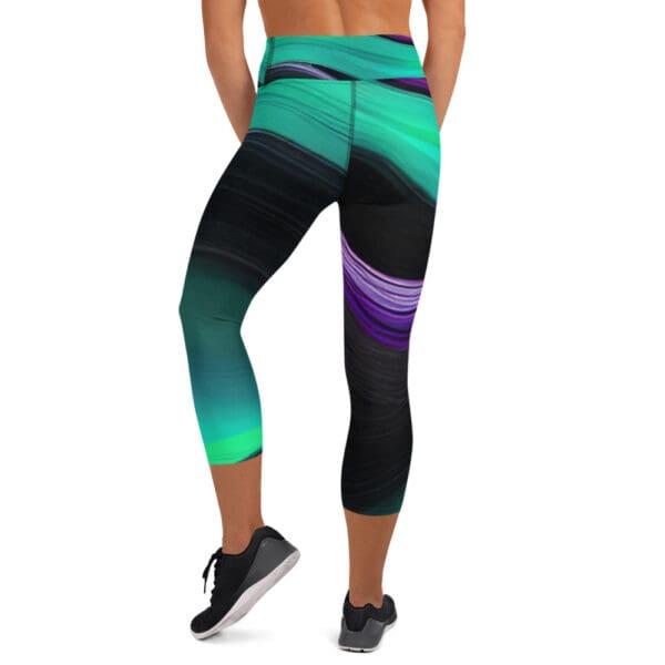 A woman is wearing black and green leggings