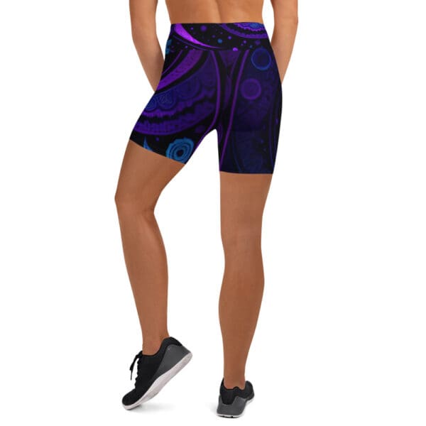 A woman wearing purple and black shorts