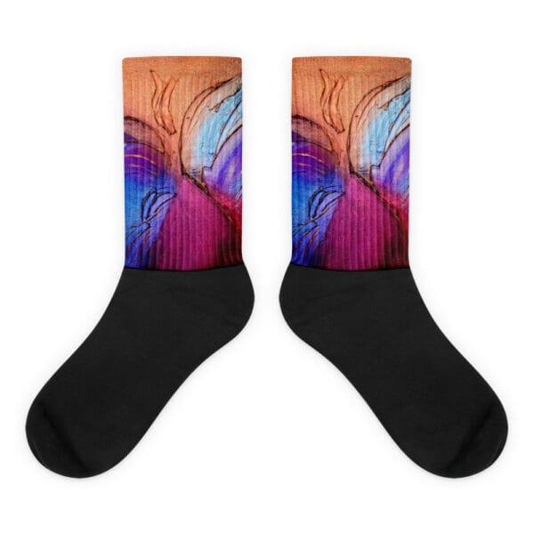 A pair of black socks with an abstract design.