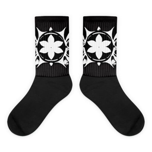 A pair of black and white socks with a design.