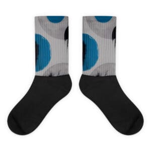 A pair of socks with blue and black polka dots.