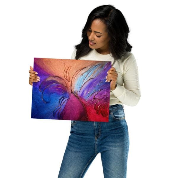 A woman holding up an image of a colorful abstract painting.