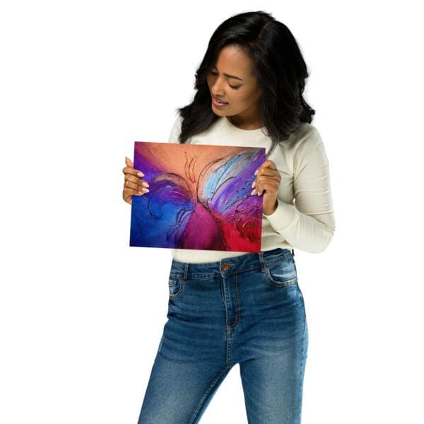 A woman holding up an image of a butterfly.